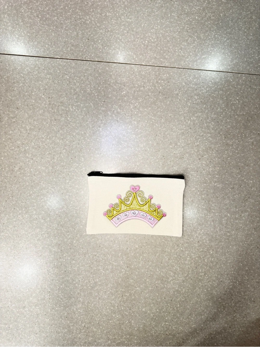 Cosmetic bag with pink crown.  Design is on both sides.